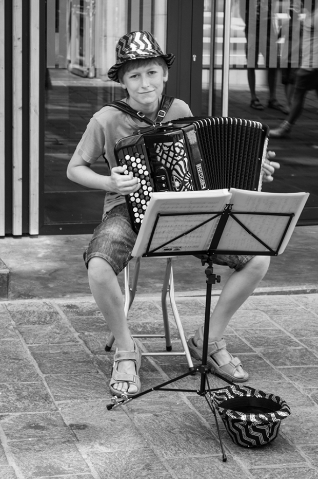 Boy playing the accordion - black and white