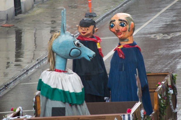 Giant puppet family looking sad in the rain